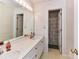 Bathroom with double vanity, a large mirror, and a shower with patterned curtains at 3605 Truxton Ct, Waxhaw, NC 28173