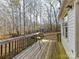 Wooden deck overlooking a wooded backyard with swing set and picnic table at 3605 Truxton Ct, Waxhaw, NC 28173