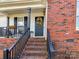 Close-up of the front entrance with brick stairs, porch columns, and a decorative wreath on the door at 3605 Truxton Ct, Waxhaw, NC 28173