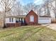 Charming single-story home with a red brick facade, attached garage, and inviting front porch at 3605 Truxton Ct, Waxhaw, NC 28173