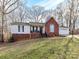 Inviting ranch-style home featuring brick accents, a cozy front porch, and a well-manicured lawn at 3605 Truxton Ct, Waxhaw, NC 28173