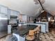 Kitchen featuring stainless steel appliances, an island with granite countertop and wooden chairs, and blue cabinetry at 3605 Truxton Ct, Waxhaw, NC 28173