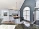 Well-lit kitchen features an island with black countertop, light blue cabinets, stainless steel appliances, and tile flooring at 3605 Truxton Ct, Waxhaw, NC 28173