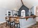 Kitchen features bar seating, gray cabinets, and a vaulted ceiling at 3605 Truxton Ct, Waxhaw, NC 28173