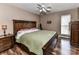 Comfortable main bedroom with wooden furniture, including a king-sized bed, a nightstand, and a dresser at 3605 Truxton Ct, Waxhaw, NC 28173