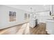 Bright, modern kitchen featuring white cabinets, stainless steel appliances, and an island with stylish pendant lights at 4105 Glenola Dr, Waxhaw, NC 28173