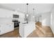 Modern kitchen with stainless steel appliances, white cabinets, a central island, and stylish pendant lighting at 4105 Glenola Dr, Waxhaw, NC 28173