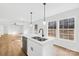 Kitchen island featuring a dual sink, seating area, and stylish pendant lighting at 4105 Glenola Dr, Waxhaw, NC 28173