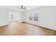 Bright and airy living room with natural light and sleek wood flooring at 4105 Glenola Dr, Waxhaw, NC 28173