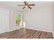 Simple bedroom with hardwood floors and a large window at 50005 Guy Ln, Norwood, NC 28128