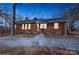 Brick ranch house with lights on at dusk, and a gravel driveway at 50005 Guy Ln, Norwood, NC 28128