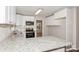 Modern kitchen featuring white cabinets, granite countertops, and stainless steel appliances at 50005 Guy Ln, Norwood, NC 28128