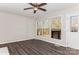 Bright living room with wood-look floors and large windows offering a view of the backyard at 50005 Guy Ln, Norwood, NC 28128