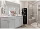 Elegant bathroom featuring a double sink vanity, framed mirror and a glass-enclosed shower at 5034 Kellaher Pl, Charlotte, NC 28216