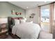 Cozy bedroom featuring stylish decor, earth tone colors, and a large window for natural light at 5034 Kellaher Pl, Charlotte, NC 28216