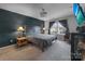 Bright bedroom featuring a dark-green accent wall and comfy bed at 603 Helms Dr, Lowell, NC 28098