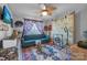 Relaxing bedroom with teal sofa, patterned rug, and gong at 603 Helms Dr, Lowell, NC 28098