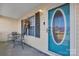 Inviting front porch with teal door and small bistro set at 603 Helms Dr, Lowell, NC 28098