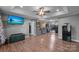 Spacious living room with hardwood floors and large TV at 603 Helms Dr, Lowell, NC 28098