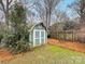 A quaint backyard shed nestled amongst mature trees at 6716 Ronda Ave, Charlotte, NC 28211