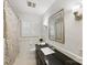 Clean bathroom with black countertop and shower/tub combo at 6716 Ronda Ave, Charlotte, NC 28211