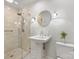 Bathroom with pedestal sink, shower, and black countertop at 6716 Ronda Ave, Charlotte, NC 28211