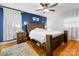 Bedroom with wood platform bed and blue accent wall at 6716 Ronda Ave, Charlotte, NC 28211