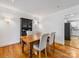 Dining room with hardwood floors, farmhouse table, and kitchen view at 6716 Ronda Ave, Charlotte, NC 28211