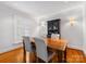 Bright dining room with hardwood floors, a wooden table, and built-in hutch at 6716 Ronda Ave, Charlotte, NC 28211