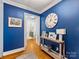 Entryway with blue walls, hardwood floors, and a console table at 6716 Ronda Ave, Charlotte, NC 28211