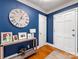 Entryway with blue walls, hardwood floors, and a console table at 6716 Ronda Ave, Charlotte, NC 28211