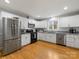 Modern kitchen with stainless steel appliances and white shaker cabinets at 6716 Ronda Ave, Charlotte, NC 28211