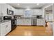 Modern kitchen with white cabinets, granite countertops, and stainless steel appliances at 6716 Ronda Ave, Charlotte, NC 28211