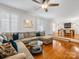 Spacious living room features hardwood floors, a sectional sofa, and access to a deck at 6716 Ronda Ave, Charlotte, NC 28211