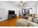 Living room with hardwood floors, sectional sofa, and built-in entertainment center at 6716 Ronda Ave, Charlotte, NC 28211