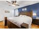 Main bedroom with dark wood platform bed and blue accent wall at 6716 Ronda Ave, Charlotte, NC 28211