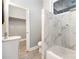 Updated bathroom with grey walls, marble tile shower/tub, and white vanity at 7117 W Sugar Creek Rd, Charlotte, NC 28269