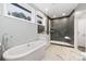 Modern bathroom featuring a soaking tub and a glass shower at 7117 W Sugar Creek Rd, Charlotte, NC 28269