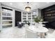 Sunlit dining area with marble floors, modern chandelier, and built-in shelving at 7117 W Sugar Creek Rd, Charlotte, NC 28269