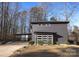 Modern dark gray house with attached garage and landscaping at 7117 W Sugar Creek Rd, Charlotte, NC 28269