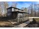 Modern home with a covered patio and walkway, surrounded by trees at 7117 W Sugar Creek Rd, Charlotte, NC 28269