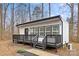 Cute cottage with black and white exterior, deck, and steps at 7117 W Sugar Creek Rd, Charlotte, NC 28269