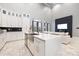 Modern kitchen with island, white cabinets, and stainless steel appliances at 7117 W Sugar Creek Rd, Charlotte, NC 28269