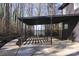 Covered patio with modern wooden privacy screen and concrete flooring at 7117 W Sugar Creek Rd, Charlotte, NC 28269