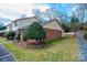 Exterior view of a brick home with a small yard and mature landscaping at 749 21St Ne Ave, Hickory, NC 28601