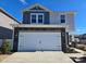 Two-story home with gray and white siding, stone accents, and a two-car garage at 800 Parkette St, Concord, NC 28027