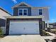 Two-story house with gray and beige siding, a two-car garage, and a landscaped yard at 800 Parkette St, Concord, NC 28027