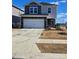 Two-story house with gray and beige siding, a two-car garage, and a landscaped yard at 800 Parkette St, Concord, NC 28027