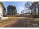 Large backyard with wooden fence and mature trees at 8018 Trotter Rd, Charlotte, NC 28216