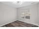 Spacious bedroom with wood-look flooring and a large window at 8018 Trotter Rd, Charlotte, NC 28216